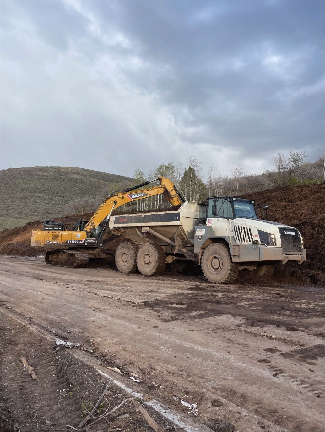 High West excavator and dump truck on a Park City job