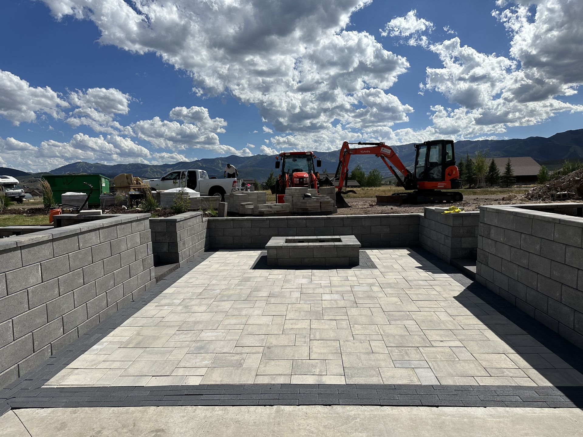 Paver patio, retaining walls, and fire pit under construction in Park City